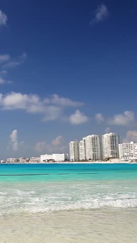 Cancun beach with blue water and resorts, Mexico. Vertical footage