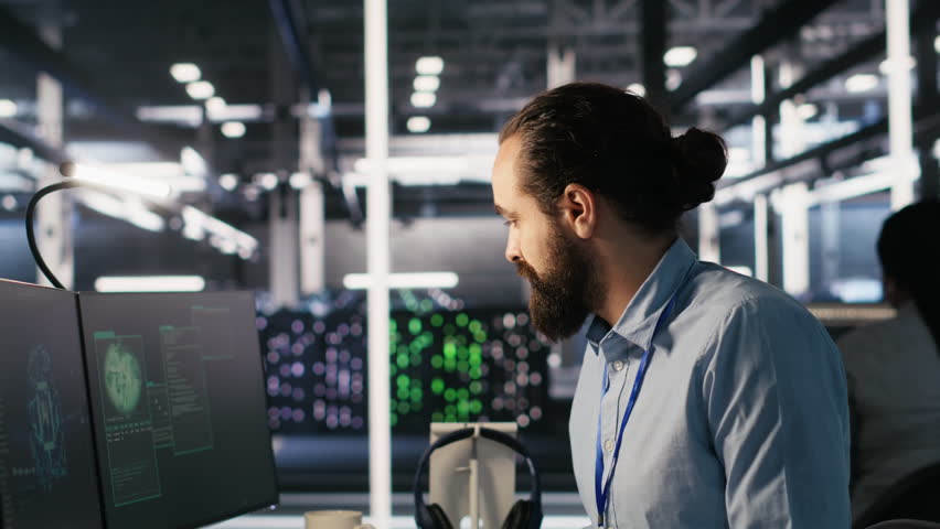 Employee requesting help from manager to fix hacked equipment systems. Stressed data center admin reacting to spyware popup on computer screen, launching emergency response protocol, camera A