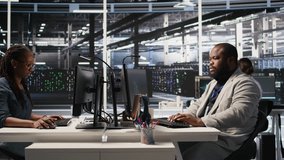 Data center system administrator monitoring servers gear performing AI training and inference tasks. Man working in server room oversees computing systems, managing deep learning operations, camera A - Powered by Shutterstock - Get 15% off with code: PIKWIZARD15