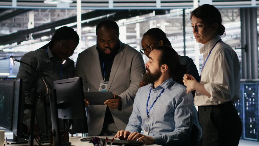 Data center system administrators performing maintenance on supercomputers used for AI processing. Team managing server hub rigs used for deep learning training, looking over business charts, camera A - Powered by Shutterstock - Get 15% off with code: PIKWIZARD15