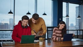 Office supervisor looking interns work in modern corporate workspace. Two friendly company trainee shaking hands greeting at workplace. Smiling colleagues planning project laptops in agency open space - Powered by Shutterstock - Get 15% off with code: PIKWIZARD15