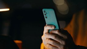 Closeup guy holding smartphone in night home. Portrait smiling businessman reading good news in cellphone email sitting dark office workplace. Happy freelancer receiving phone salary notification. - Powered by Shutterstock - Get 15% off with code: PIKWIZARD15