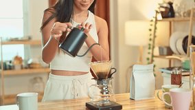 Female hands pouring hot water into a coffee filter - Powered by Shutterstock - Get 15% off with code: PIKWIZARD15