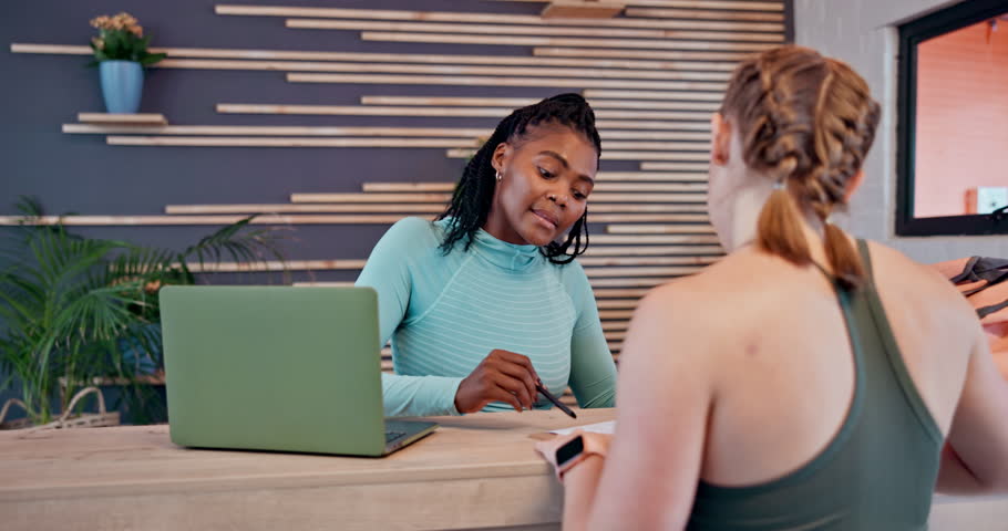 Happy women, gym and receptionist with application on laptop for membership or sign up at front desk. Female people, client or registration with computer, form or survey for policy at health club