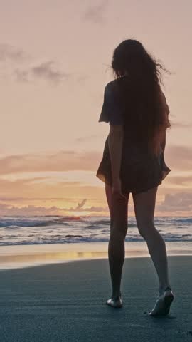 Beautiful Woman Walking on Sandy Beach and Wet Legs Stepping on Sand. Alone Adult Girl at Bright Scenic Sea Going Swim or Splash. Modern Romance of Ocean Bathing and Gorgeous Summer Sky at Shoreline