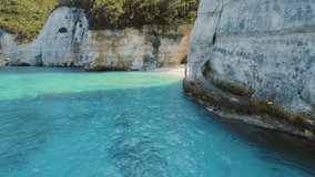 Woman jumping into turquoise waters at White Cliffs Beach Ionian Island Greece - Powered by Shutterstock - Get 15% off with code: PIKWIZARD15