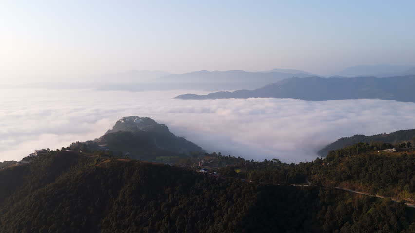 Drone circling the Gyarjati town in the hills of Pokhara, foggy sunrise in Nepal
