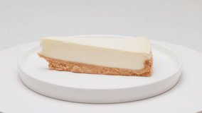 Classic dessert cheesecake on plate close-up. Cheesecake is a dessert made with a soft fresh cheese , typically cottage cheese, cream cheese, quark or ricotta, eggs, and sugar. It may have a crust or - Powered by Shutterstock - Get 15% off with code: PIKWIZARD15