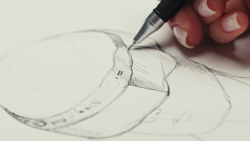 Young woman artist is drawing 3d glasses by pencil on white paper . VR developer making sketches for the of virtual reality glasses of the future close-up. Drawing and sketching lessons