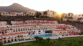 Scenic sunrise over Tenerife’s Costa Adeje with terraced resorts and mountains - Powered by Shutterstock - Get 15% off with code: PIKWIZARD15