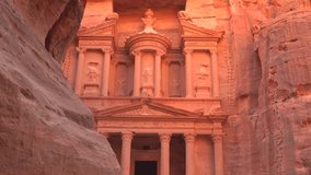 The iconic facade of Al-Khazneh, the Treasury, carved into the sandstone cliffs of the ancient city of Petra, Jordan. - Powered by Shutterstock - Get 15% off with code: PIKWIZARD15