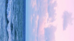 Vertical, Sea Waves Horizon, Beautiful Colorful Sunset, Ocean Slow Motion. Amazing Pink Lilac Sky Sun Cumulus Colorful Lilac Pink Clouds Sea Island Vacation. Skyscraper at Sunrise Sea Background, Bay. - Powered by Shutterstock - Get 15% off with code: PIKWIZARD15