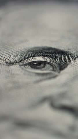 Macro video. Close-up of US 100 dollar bill. Rotation of 100 dollar. Details and texture of American cash. Emphasis on eyes of portrait Benjamin Franklin on US banknote. Finance, business and banking.