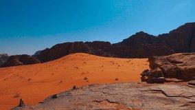 Desert landscape with red sand dunes and rocky mountains resembling the surface of Mars or a red planet. - Powered by Shutterstock - Get 15% off with code: PIKWIZARD15