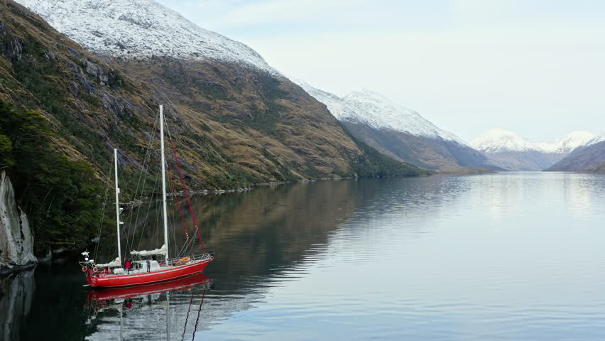 Floating Boat Over Beagle Channel Around Cape Horn In Tierra del Fuego, Argentina, South America. Aerial Drone Shot
