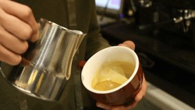 Steamed milk pours into espresso. Ceramic cup fills with creamy layers. Barista crafts latte art heart. Silky microfoam blends with crema. Stainless pitcher tilts precisely. Warm café lighting highlig - Powered by Shutterstock - Get 15% off with code: PIKWIZARD15