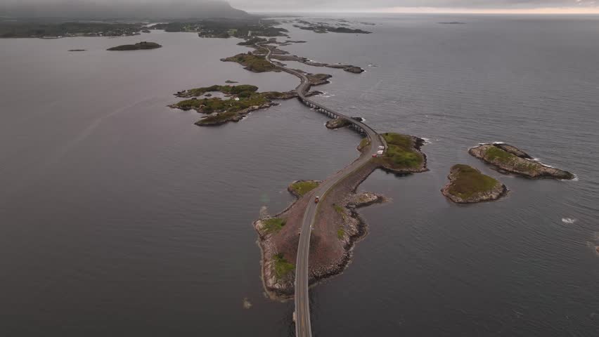 A drone view of the Atlantic Ocean road on the calm Norwegian Sea at dusk in More og Romsdal county, Norway