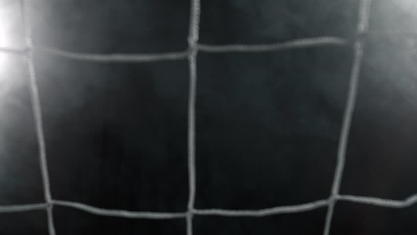 Super Slow Motion Soccer Ball Hitting Goal Net on Black Background, 1000fps.