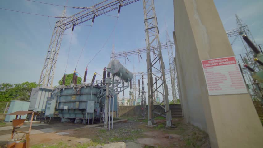 Electrical Transformer with Power Lines and Emergency Contact Sign