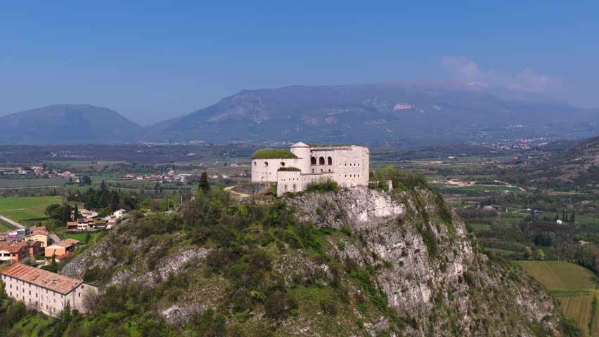 Wide aerial flyover tilt down Rivoli Fort, Italy, historic fortress on cliff