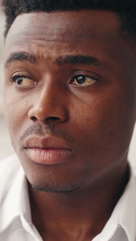 Depression and frustration, psychological problems of modern people, closeup portrait of unhappy african american man. Vertical video, black male person feeling sadness and anxiety, emotional face