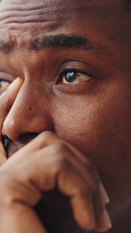 Depression and frustration, psychological problems of modern people, closeup portrait of unhappy african american man. Vertical video, black male person feeling sadness and anxiety, emotional face