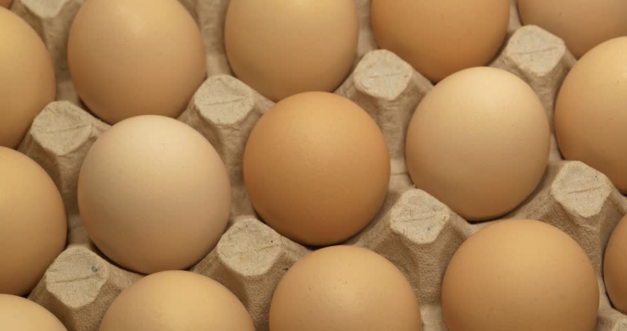 Chicken eggs in tray. Fresh chicken eggs. Cinema 4K 60fps video