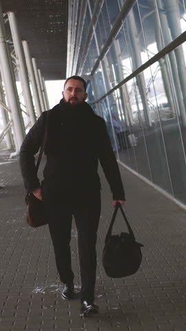 Vertical Video of Full Body View Of Businessman With Suitcase At The Airport Walking. Man business and travel with work for corporate, professional and luggage for airport to plane.