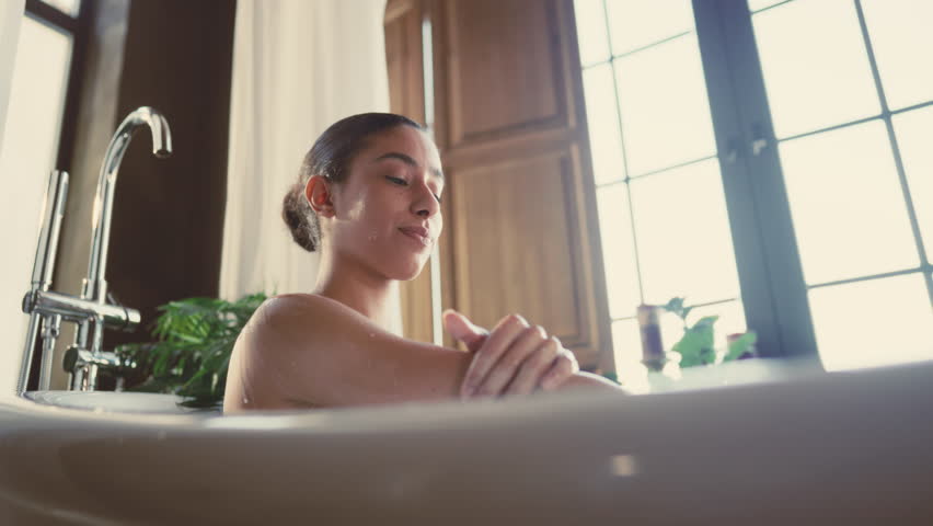 Happiness and pleasure, woman taking bath for relaxing and moisturizing skin. Attractive female person stroking her body, aromatherapy and beauty treatments for anti-stress effect for body and mind