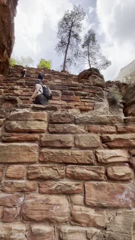Hikers climb Walters Wiggles switchbacks in Zion National Park
