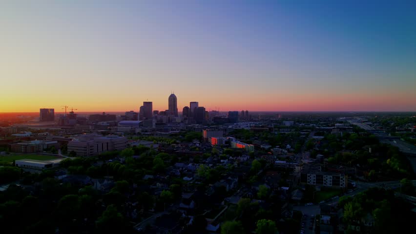 Aerial view of Indianapolis Indiana skyline at sunset with glowing horizon