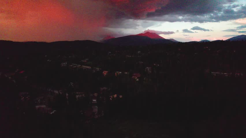 Aerial footage of a fire sunrise in Breckenridge Colorado. Camera is rising up slowly.