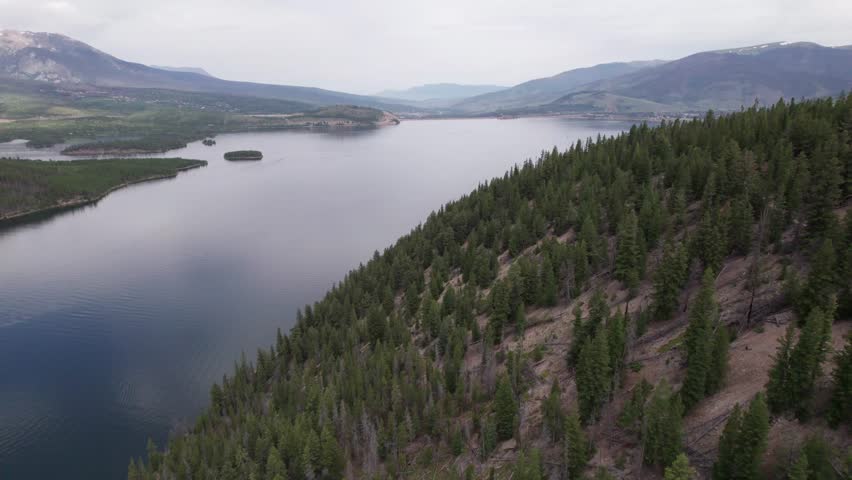 Aerial video of Dillon Reservoir near Sapphire Point Overlook in Breckenridge, Colorado.. Camera is flying over forest.