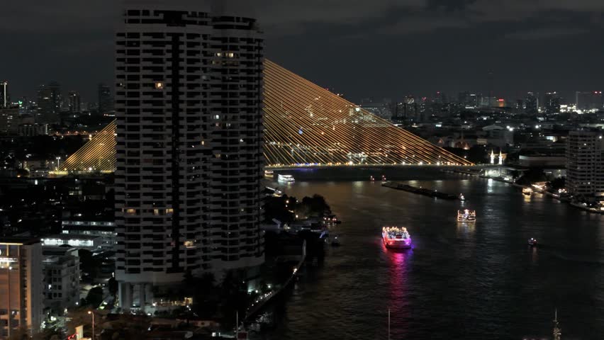Rama VIII Bridge and Rattanakosin View Mansion at night in Bangkok, Thailand
