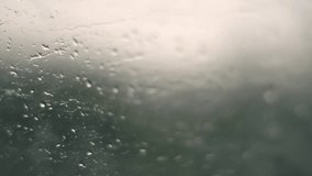 Foggy car window covered with rain drops, moisture and condensation obscure outside view, creating cold and moody atmosphere. - Powered by Shutterstock - Get 15% off with code: PIKWIZARD15