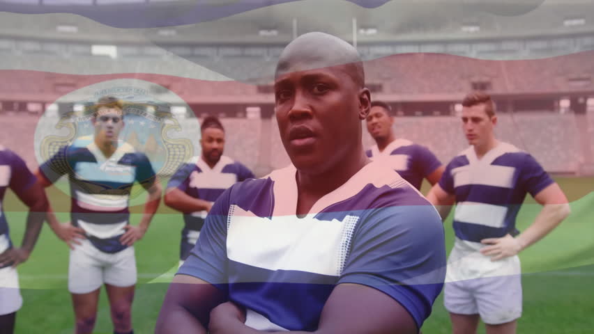 Rugby teammates standing on turf, far-left player introducing ball and preparing group for play. Athletes, team, camaraderie, competition, sporty, outdoor, resilience
