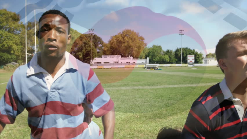 Rugby player sprinting and contesting ball for possession while opponent lifting under logo overlay. Athletics, competition, vigor, teamwork, outdoor, dynamic, sportsmanship