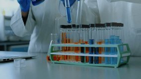 Upon pipette lifting lab technicians dispensing blue solution, linking with floating DNA helix. Science, research, innovation, collaboration, laboratory, experimentation, technology - Powered by Shutterstock - Get 15% off with code: PIKWIZARD15