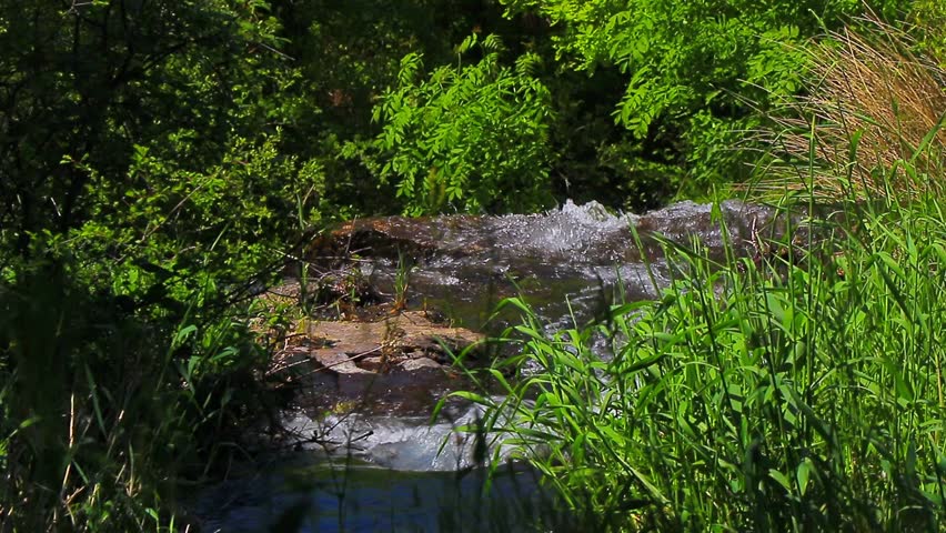 A 20-second still video of the Alzeau River waterfall in Saint Denis, Aude. A waterfall set amidst rocks in the south of France.