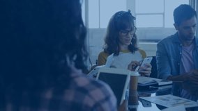 Group colleagues tapping devices at office table, generating animated network icons connecting team. Collaboration, networking, technology, teamwork, innovation, professional, digital - Powered by Shutterstock - Get 15% off with code: PIKWIZARD15