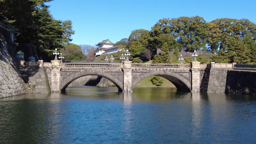 A breathtaking shot of the stone bridge and moat at the Imperial Palace in Tokyo, Japan, showcasing the serene and historic architecture.