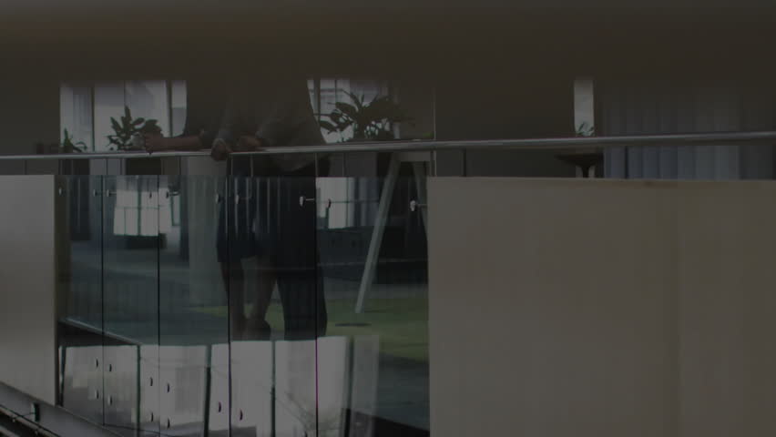 Digital glitch revealing globe, two colleagues leaning on rail nodding driving business strategy. Futuristic, collaboration, innovation, corporate, technology, networking, modern