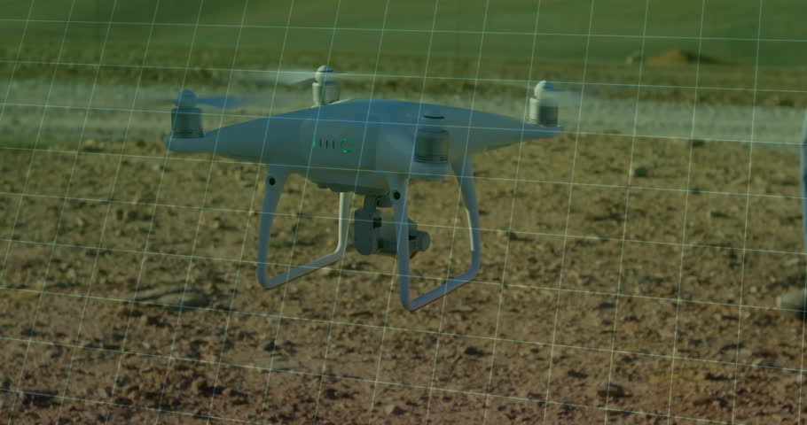 Drone operator raising controller and adjusting drone flight and tracking graph over wind turbines. Aerial, exploration, technology, digital, industrial, landscape, innovation