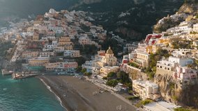 Famous tourist resort of the Amalfi coast - Positano at sunset. Flying above colorful houses, church and beach with turquoise water - Positano village, Italy. UHD, 4K - Powered by Shutterstock - Get 15% off with code: PIKWIZARD15