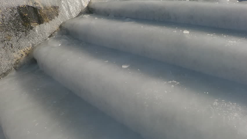 Close-up of slippery steps covered with ice-crusted, Staircase covered with a layer of ice