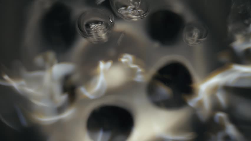 Water flowing down the drain, macro shot with probe lens under water
