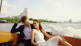 Happy Caucasian man and woman couple enjoy urban lifestyle travel city on luxury private boat yacht sailing in the river and looking beautiful cityscape skyline at sunset on summer holiday vacation. - Powered by Shutterstock - Get 15% off with code: PIKWIZARD15