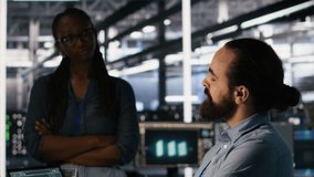 Data center system administrators working together, collaborating on neural network software development. Server hub worker and african american colleague implementing AI tech in workplace, camera A - Powered by Shutterstock - Get 15% off with code: PIKWIZARD15
