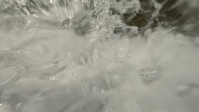 Waterfall water flow falling down splashing water droplets into camera lens sparkling in bright sunlight, super slow motion, extreme close-up - Powered by Shutterstock - Get 15% off with code: PIKWIZARD15