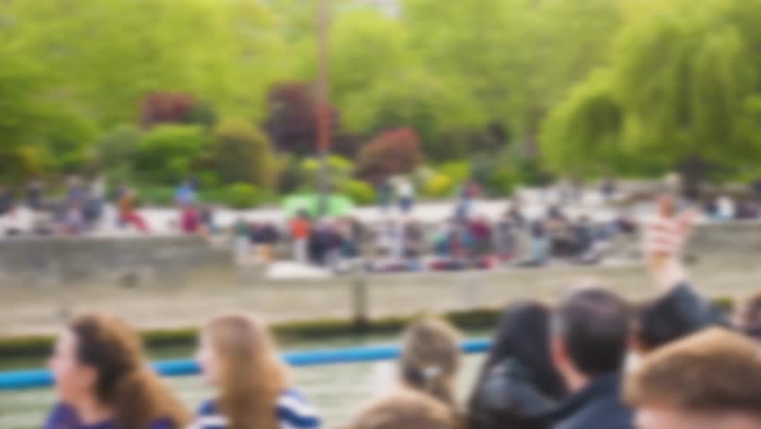 Riverboat cruise on the Seine. View from the deck of a cruise boat on tourists, Isle of Cite (Ile de la Cite) in spring. Out of focus. Paris, France.